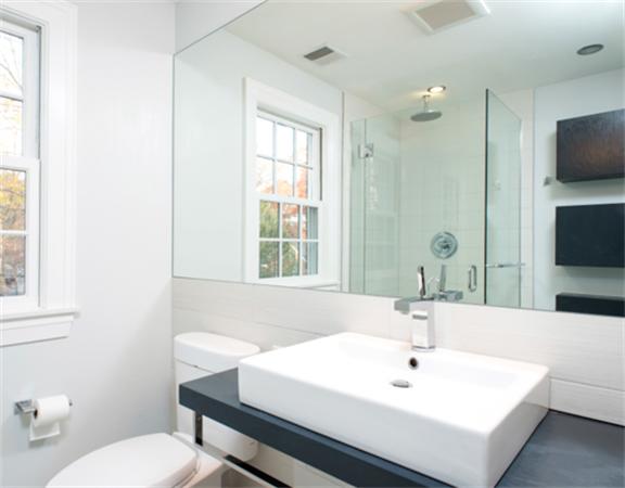 26 Whitney Road Newton, MA 02460 - Photo 15 of 29 a bathroom with a sink a toilet and a mirror