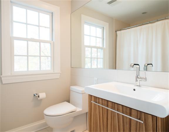 26 Whitney Road Newton, MA 02460 - Photo 17 of 29 a bathroom with a sink a toilet and a window