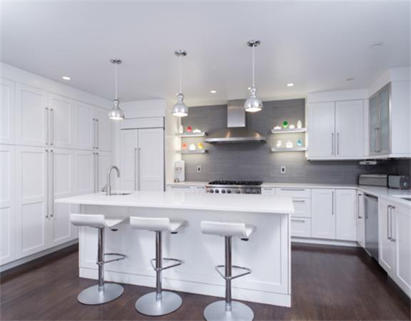 26 Whitney Road Newton, MA 02460 - Photo 10 of 29 a kitchen with stainless steel appliances granite countertop a table chairs stove and refrigerator