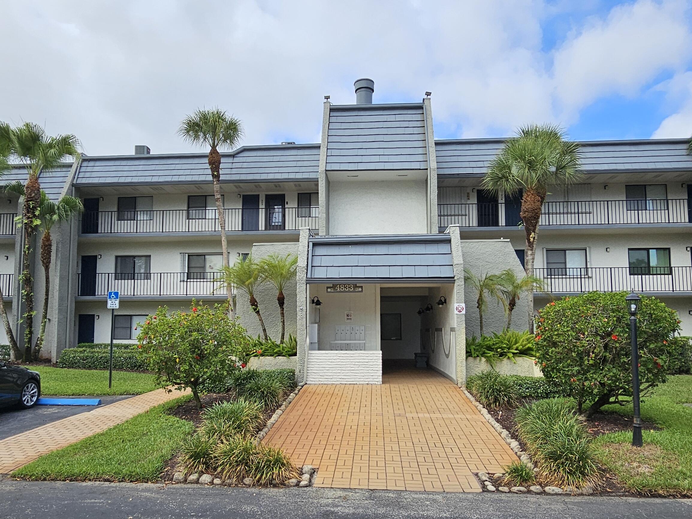 a front view of a house with a garden and plants