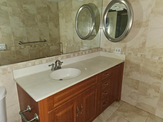 a bathroom with a sink a vanity and a mirror