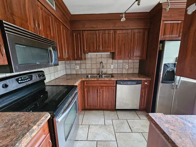 a kitchen with a stove microwave and sink