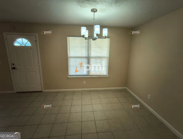 en empty room with window and chandelier fan