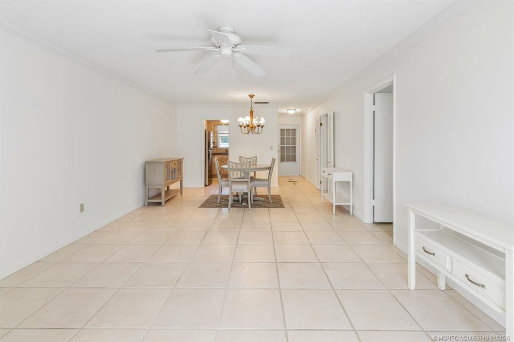 1909 Southwest Palm City Road, Unit B Stuart, FL 34994 - Photo 11 of 36 a view of a livingroom with furniture and chandelier