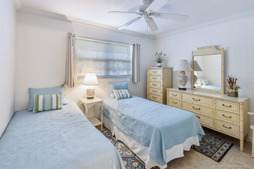 1909 Southwest Palm City Road, Unit B Stuart, FL 34994 - Photo 13 of 36 a bedroom with a bed and dresser with mirror