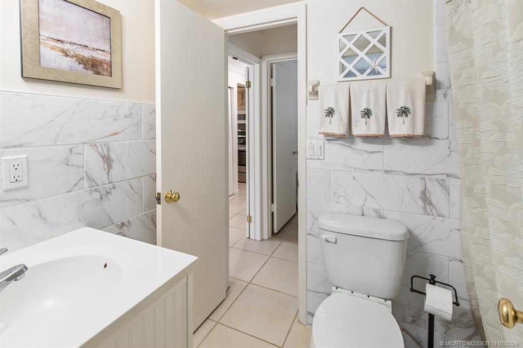 1909 Southwest Palm City Road, Unit B Stuart, FL 34994 - Photo 15 of 36 a bathroom with a toilet sink and shower