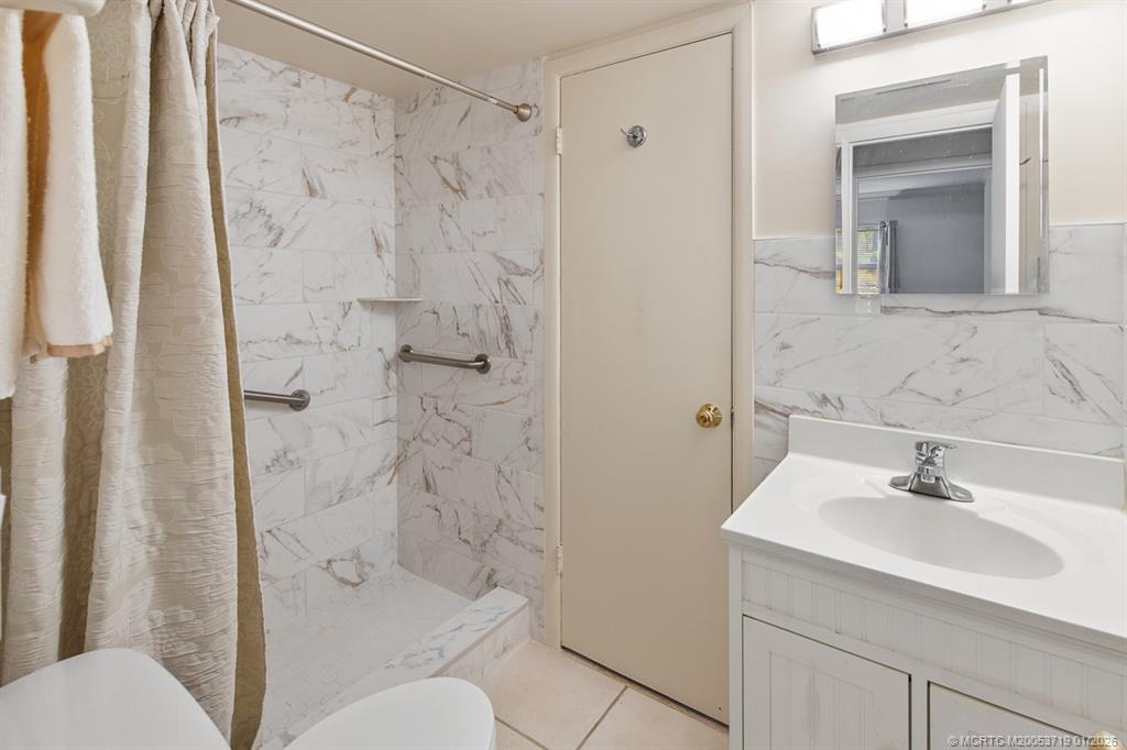 1909 Southwest Palm City Road, Unit B Stuart, FL 34994 - Photo 16 of 36 a bathroom with a sink toilet and shower