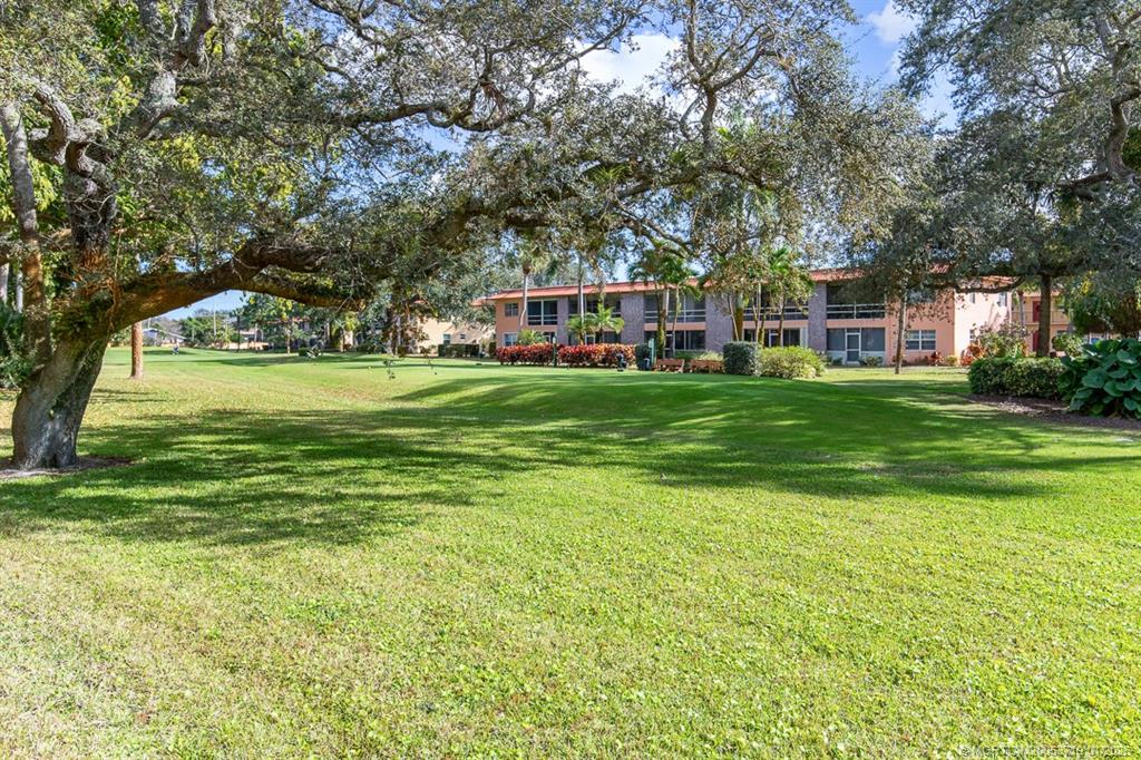 1909 Southwest Palm City Road, Unit B Stuart, FL 34994 - Photo 19 of 36 a front view of a house with a garden