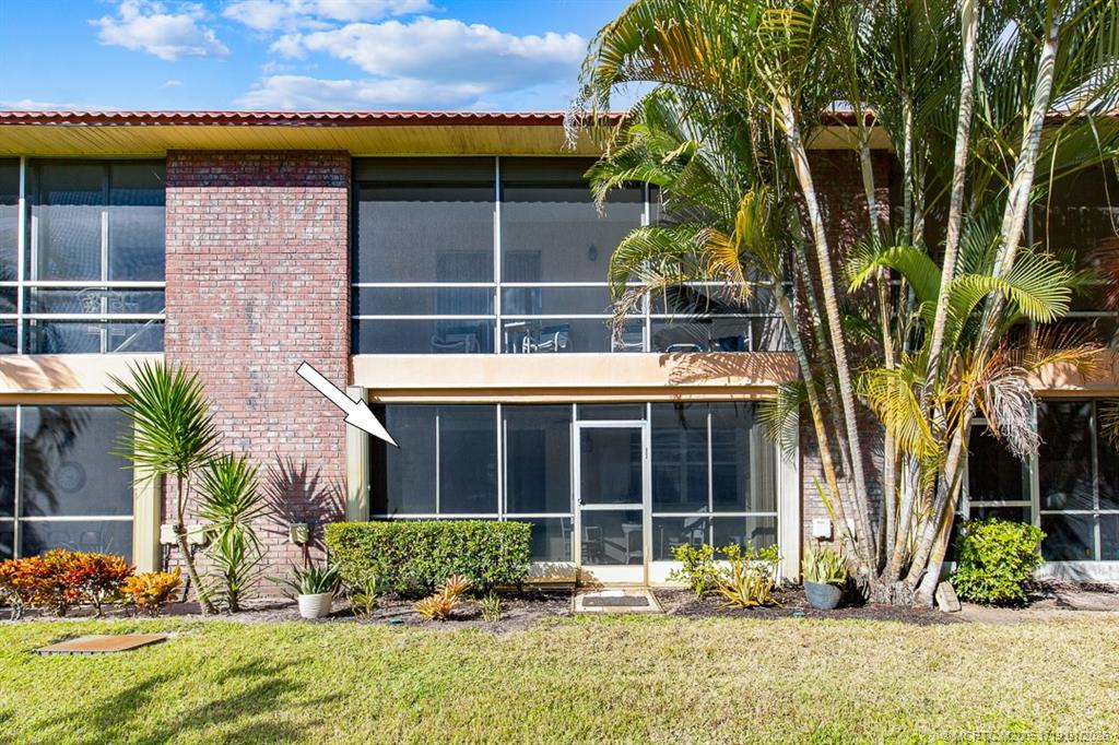 1909 Southwest Palm City Road, Unit B Stuart, FL 34994 - Photo 21 of 36 a front view of a house with a yard