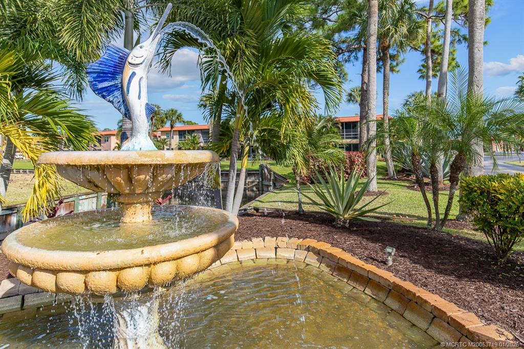 1909 Southwest Palm City Road, Unit B Stuart, FL 34994 - Photo 28 of 36 a view of a swimming pool with a patio and plants