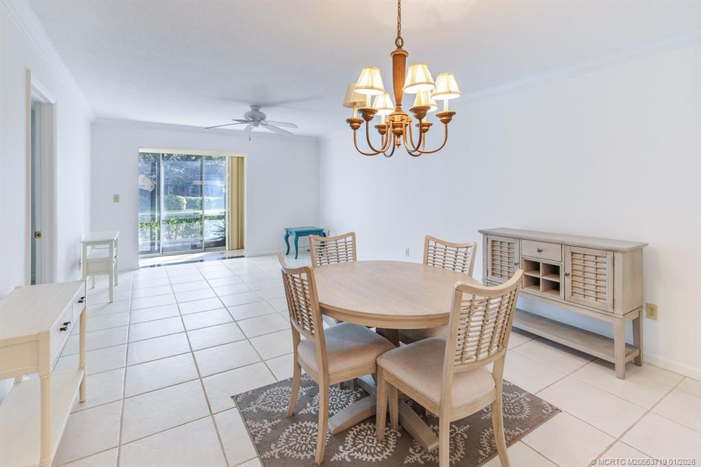 1909 Southwest Palm City Road, Unit B Stuart, FL 34994 - Photo 9 of 36 a view of a dining room with furniture a chandelier and window