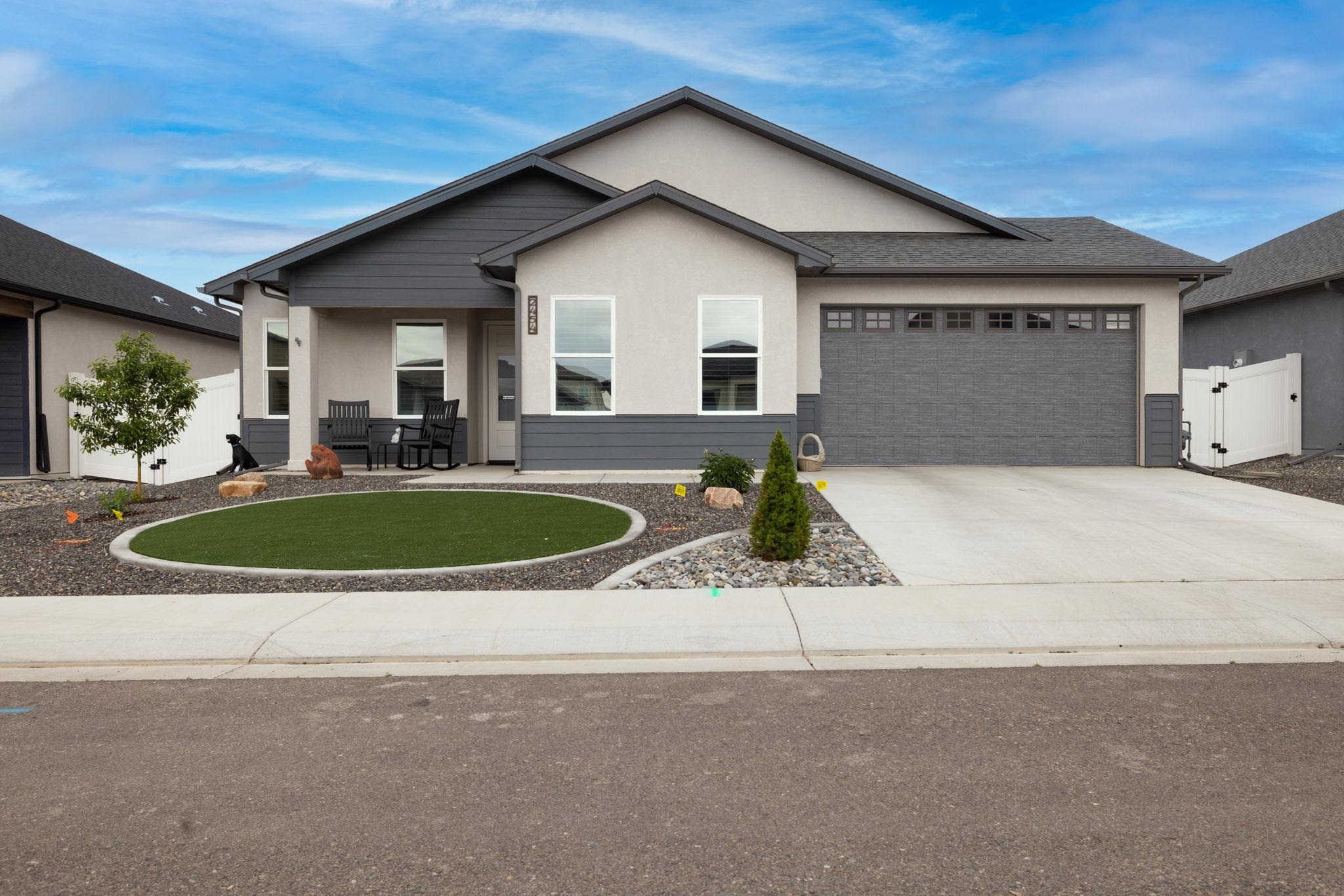 a view of a house with backyard and sitting area
