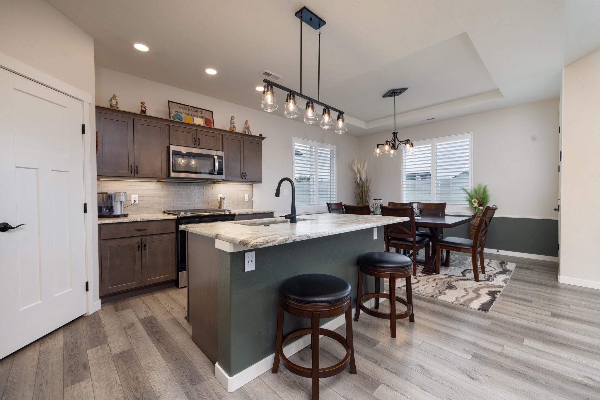 2454 Ross Road Grand Junction, CO 81505 - Photo 13 of 31 a large kitchen with a table and chairs in it