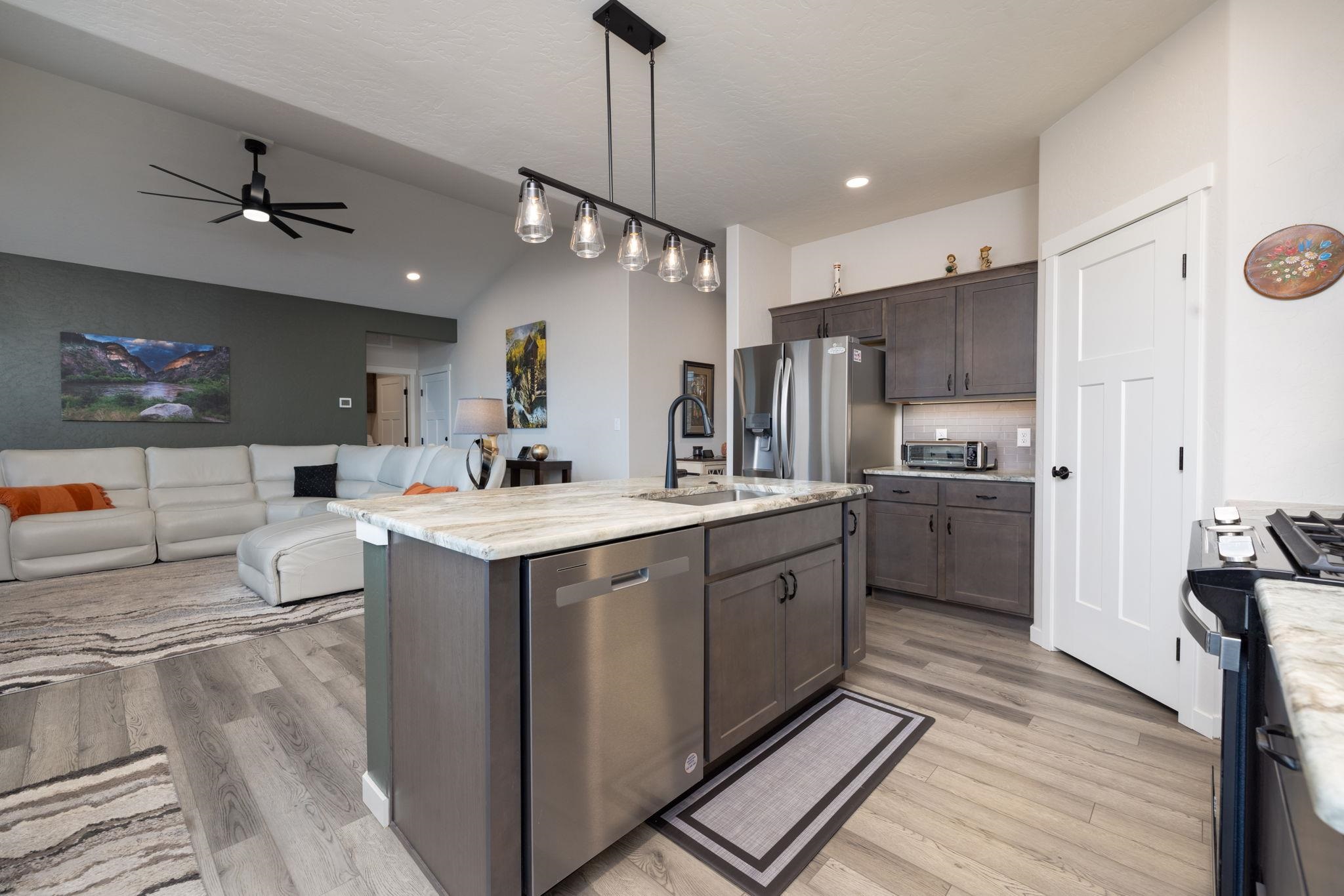2454 Ross Road Grand Junction, CO 81505 - Photo 15 of 31 a large kitchen with kitchen island a sink stainless steel appliances and cabinets