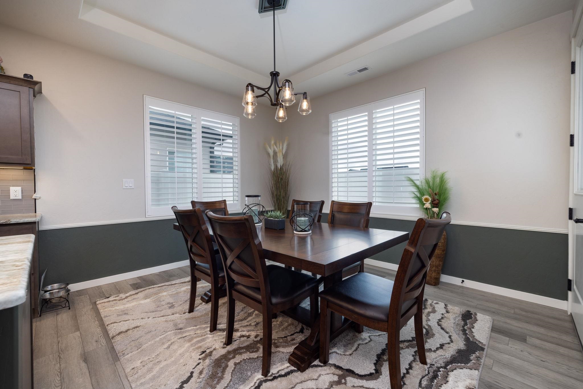2454 Ross Road Grand Junction, CO 81505 - Photo 17 of 31 a view of a dining room with furniture window and wooden floor