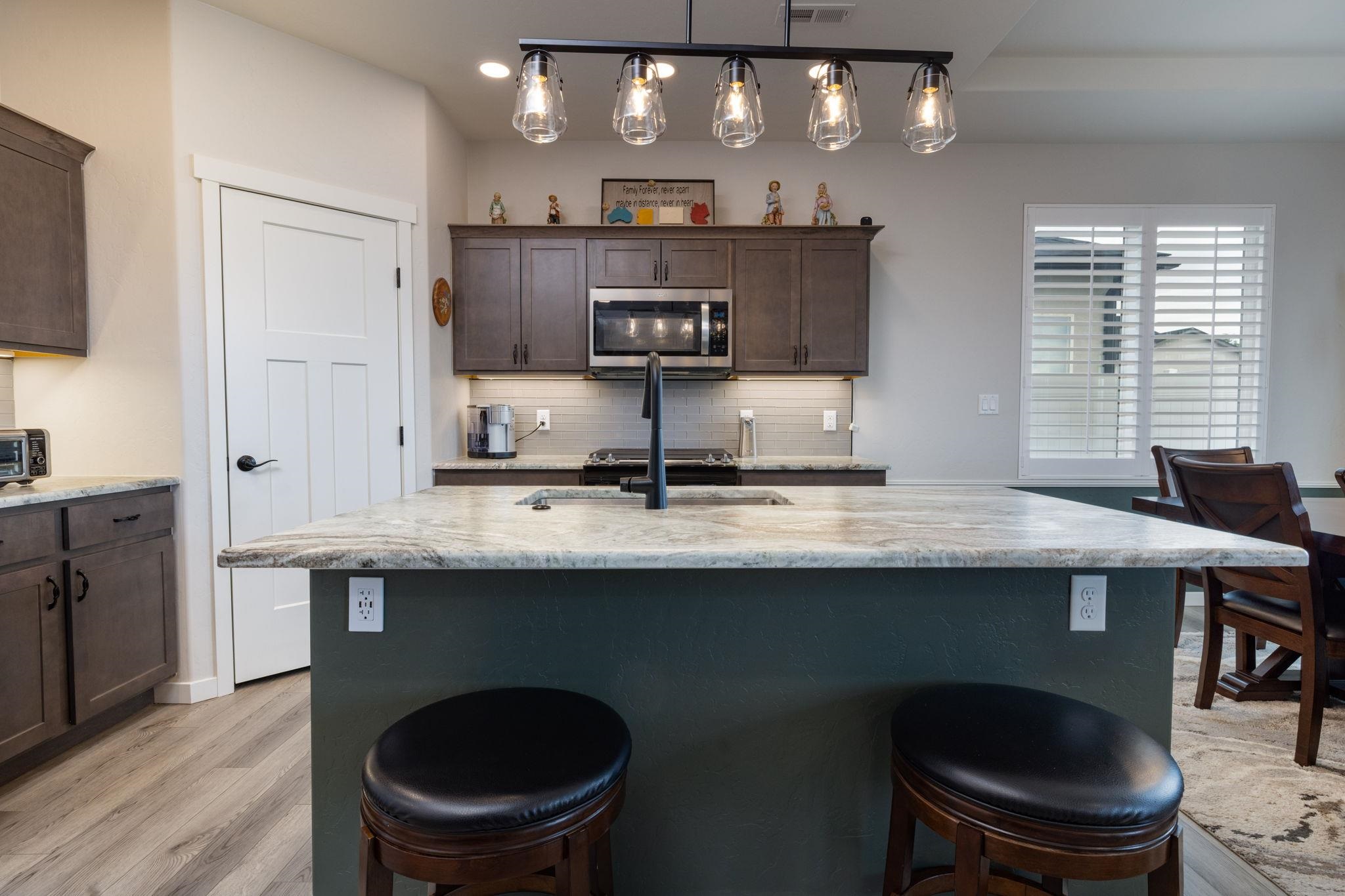 2454 Ross Road Grand Junction, CO 81505 - Photo 21 of 31 a kitchen with stainless steel appliances granite countertop a sink a stove and a refrigerator