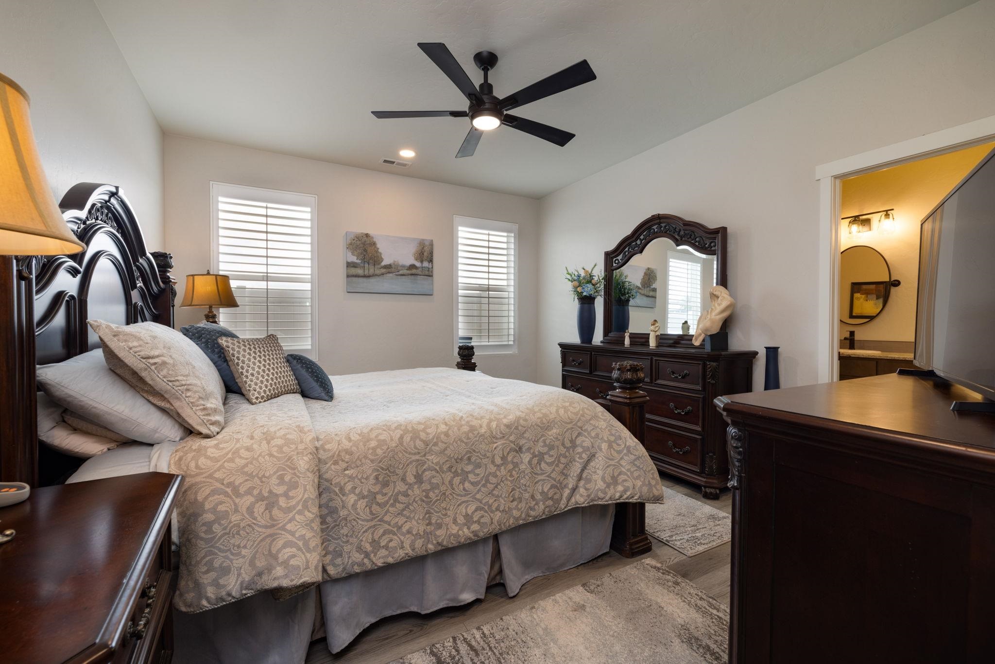 2454 Ross Road Grand Junction, CO 81505 - Photo 23 of 31 a bedroom with a bed a dresser and potted plants