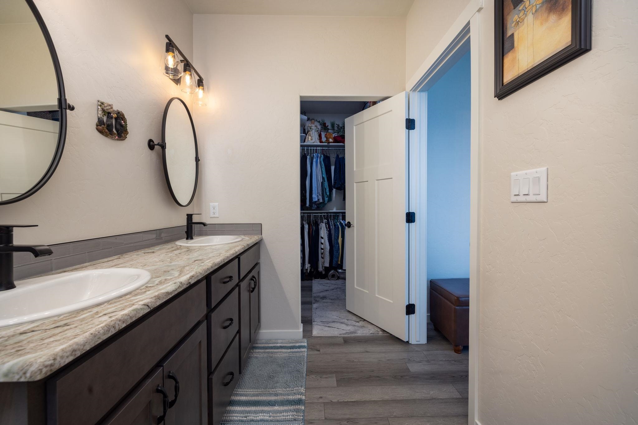 2454 Ross Road Grand Junction, CO 81505 - Photo 27 of 31 a bathroom with a granite countertop sink and a mirror