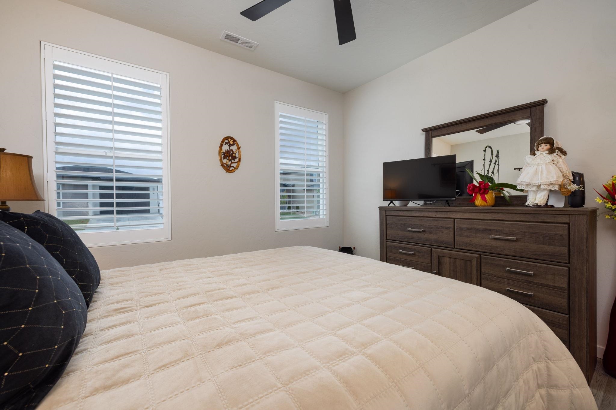2454 Ross Road Grand Junction, CO 81505 - Photo 5 of 31 a bedroom with a bed and a flat screen tv