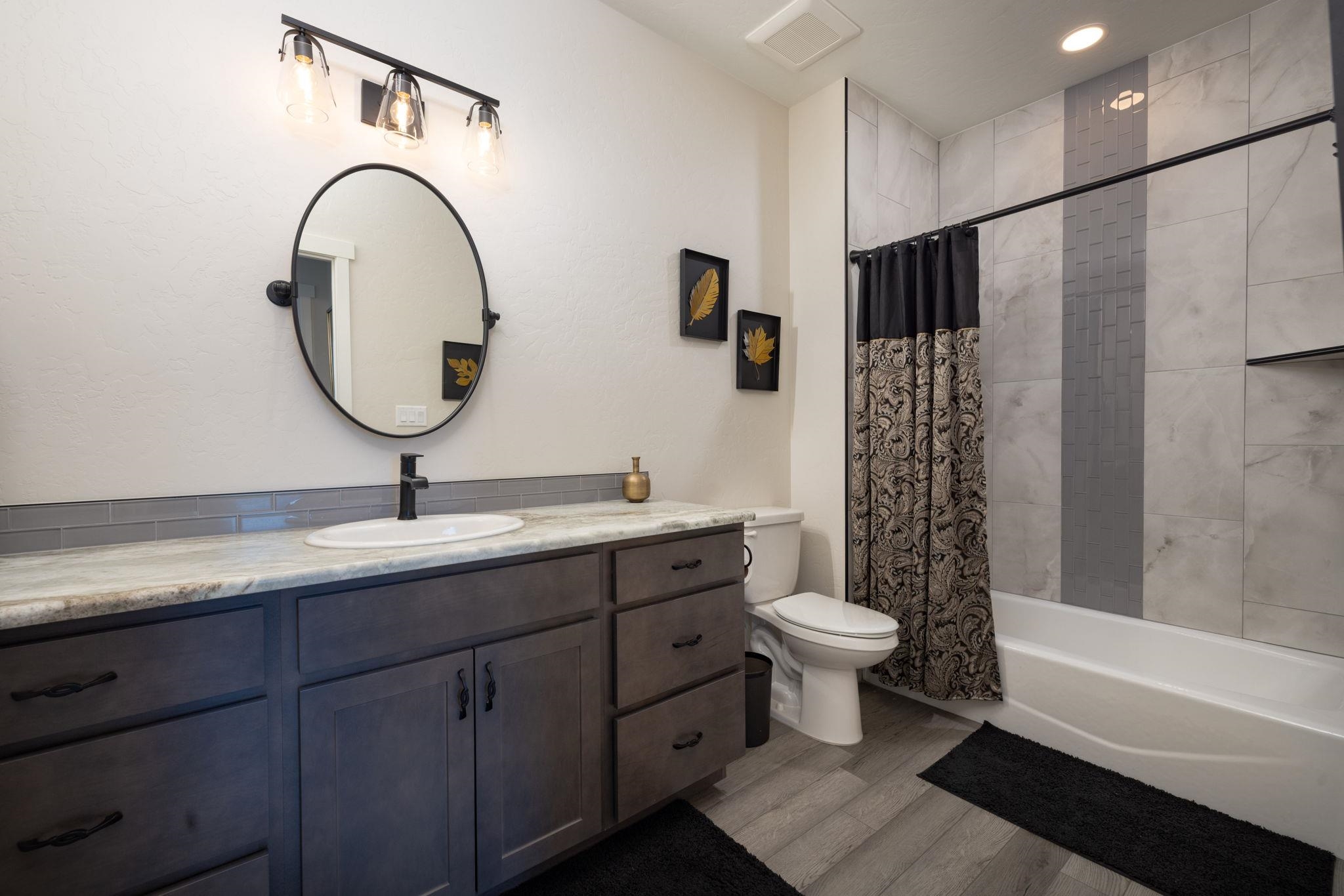 2454 Ross Road Grand Junction, CO 81505 - Photo 7 of 31 a bathroom with a double vanity sink and a mirror