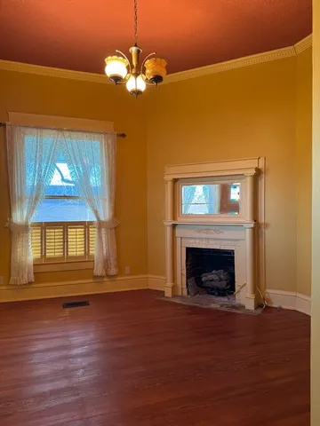 a view of livingroom with fireplace wooden floor and windows