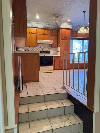 a kitchen with stainless steel appliances granite countertop a stove and a refrigerator