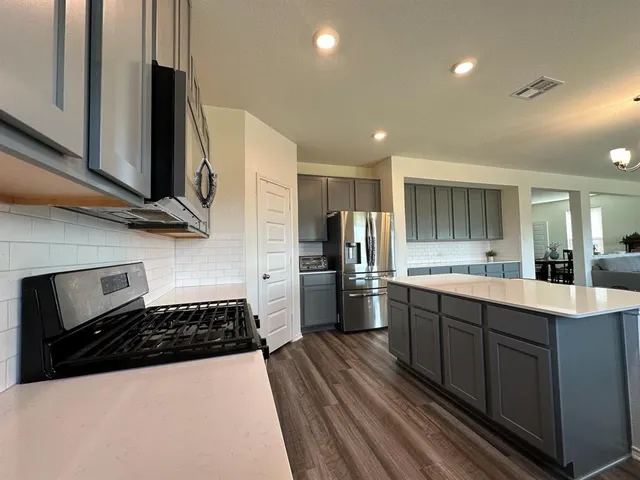 a kitchen with stainless steel appliances a sink stove and refrigerator