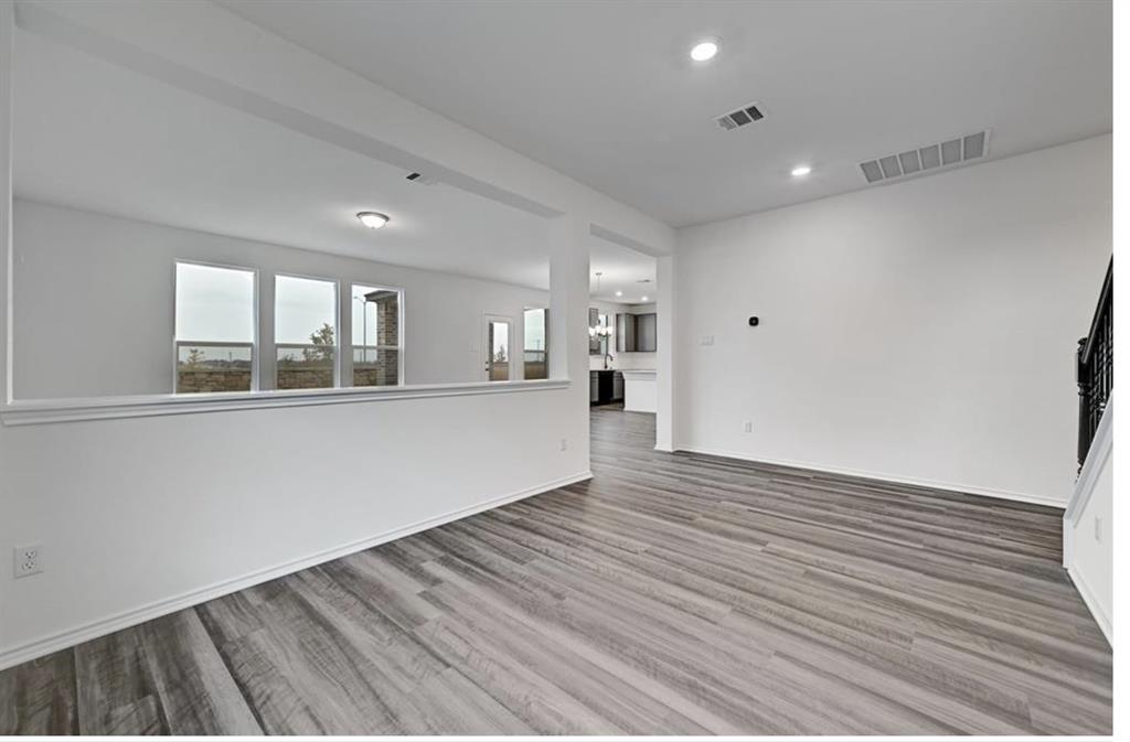 4553 Dugenta Place Round Rock, TX 78665 - Photo 21 of 38 a view of empty room with wooden floor and fan