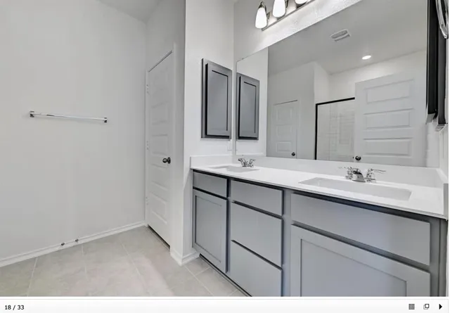 a bathroom with a sink double vanity and a mirror