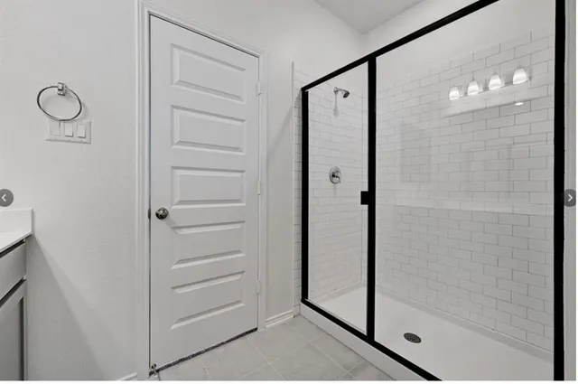 a bathroom with a shower and a glass door