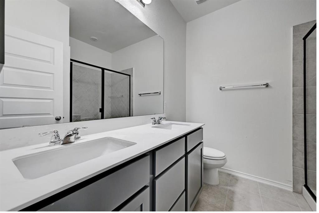 4553 Dugenta Place Round Rock, TX 78665 - Photo 35 of 38 a bathroom with a sink and a mirror