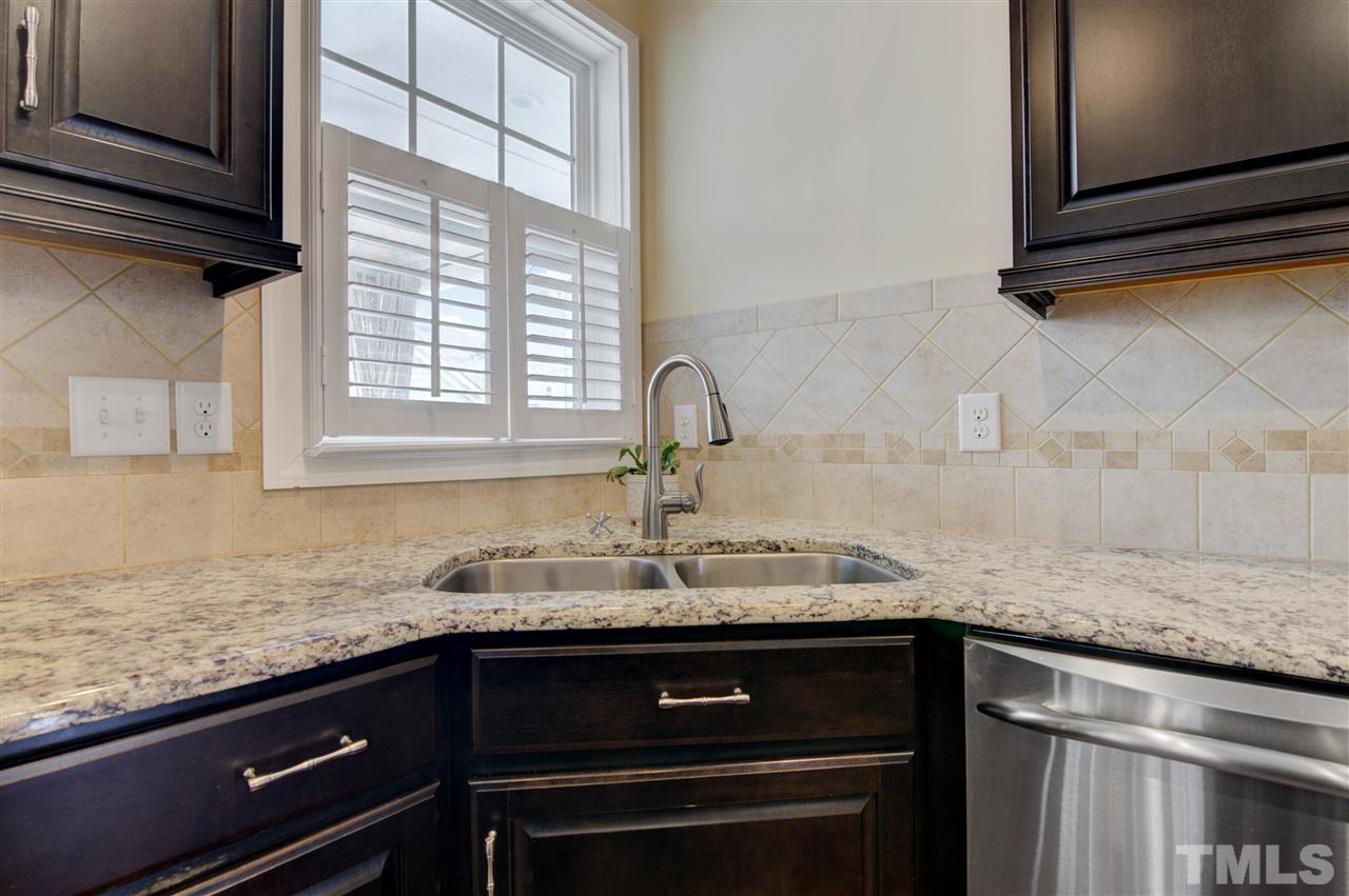1585 Fullerton Place Raleigh, NC 27607 - Photo 12 of 30 a kitchen with granite countertop a sink and cabinets