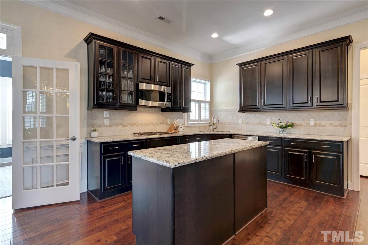 1585 Fullerton Place Raleigh, NC 27607 - Photo 13 of 30 a kitchen with stainless steel appliances granite countertop a stove a sink and a microwave