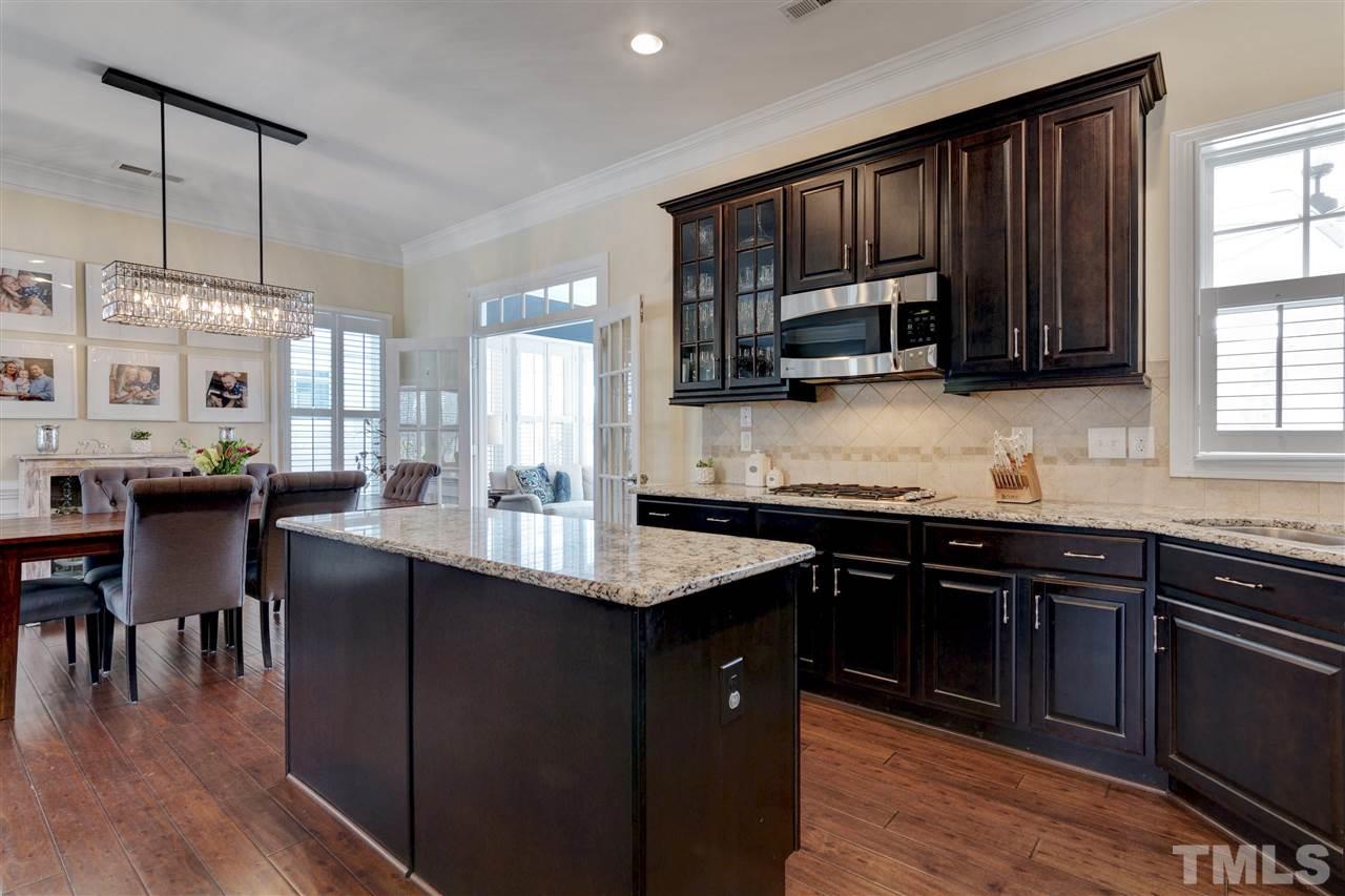 1585 Fullerton Place Raleigh, NC 27607 - Photo 14 of 30 a kitchen with granite countertop a sink cabinets and stainless steel appliances