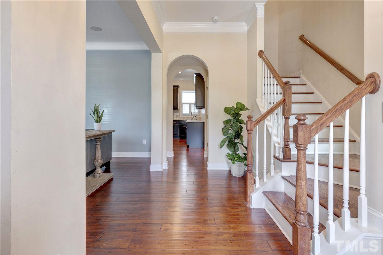 1585 Fullerton Place Raleigh, NC 27607 - Photo 3 of 30 a view of an entryway with wooden floor and a potted plant