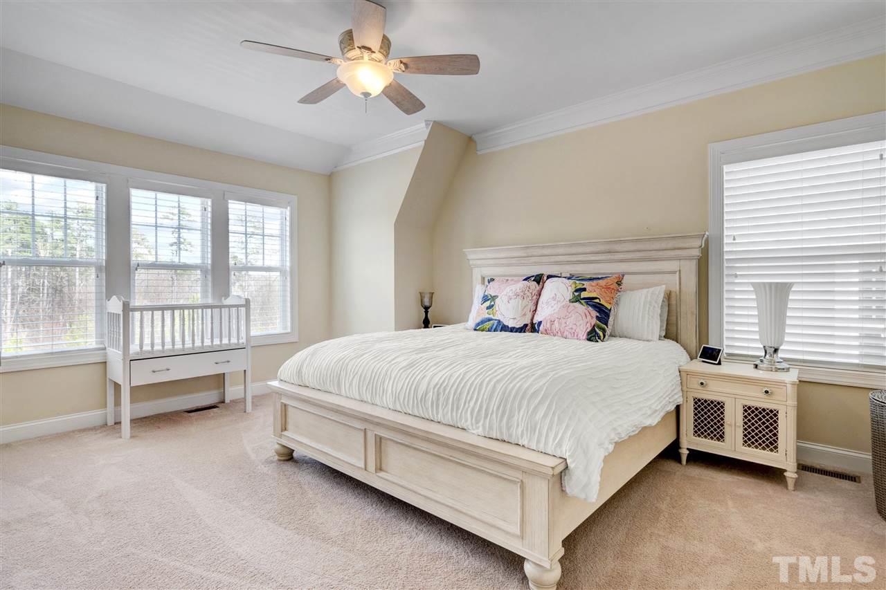 1585 Fullerton Place Raleigh, NC 27607 - Photo 21 of 30 a bed sitting in a room next to a window