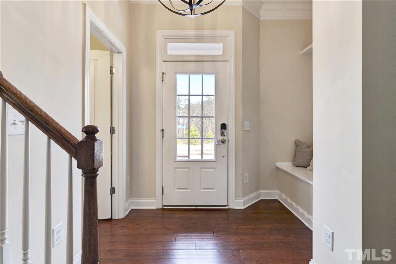 1585 Fullerton Place Raleigh, NC 27607 - Photo 4 of 30 a view of an entryway with wooden floor and door