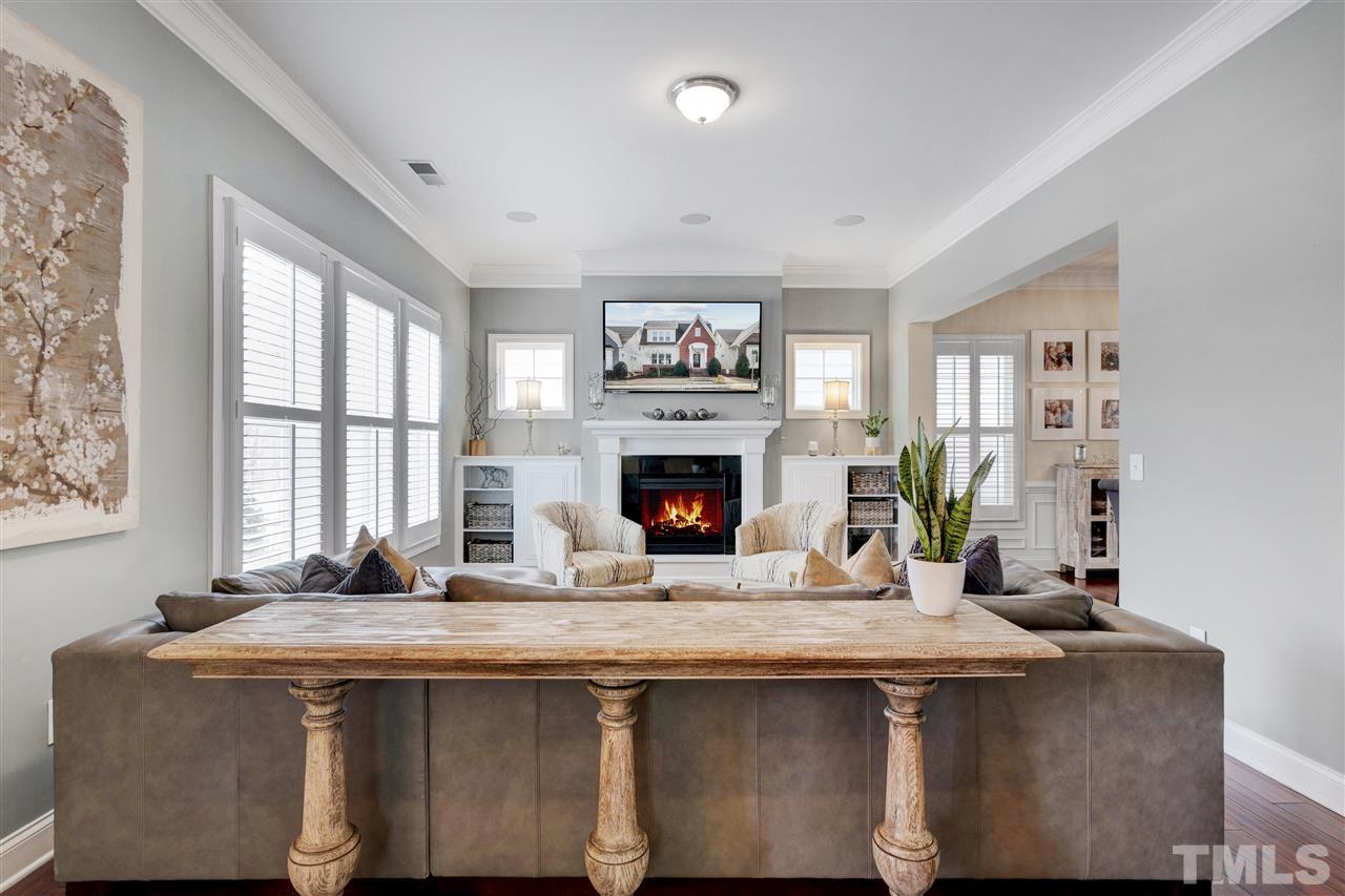 1585 Fullerton Place Raleigh, NC 27607 - Photo 5 of 30 a living room with granite countertop furniture a fireplace and windows