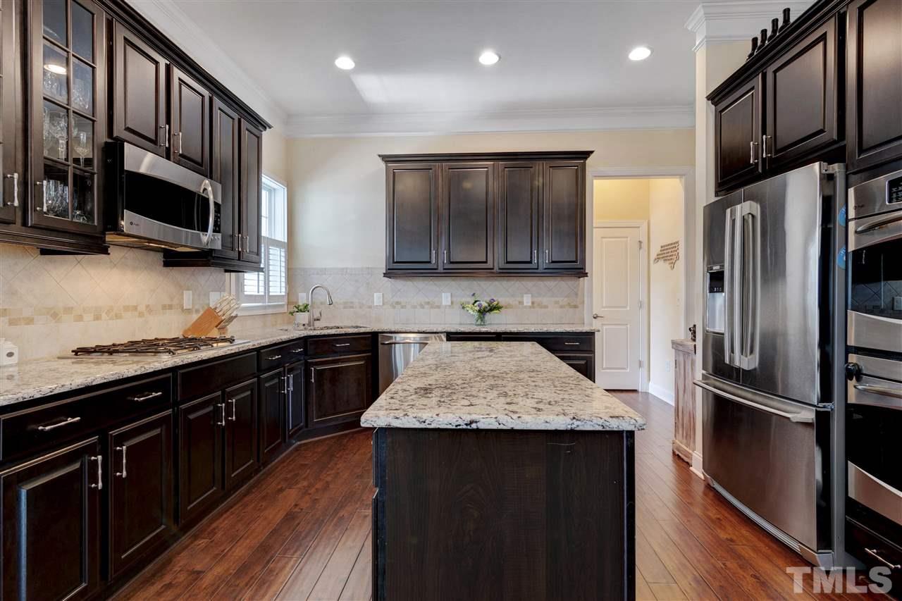 1585 Fullerton Place Raleigh, NC 27607 - Photo 10 of 30 a kitchen with stainless steel appliances granite countertop a refrigerator a stove top oven a sink and dishwasher