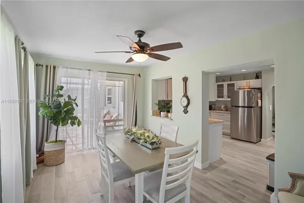 a view of a dining room with furniture and a potted plant
