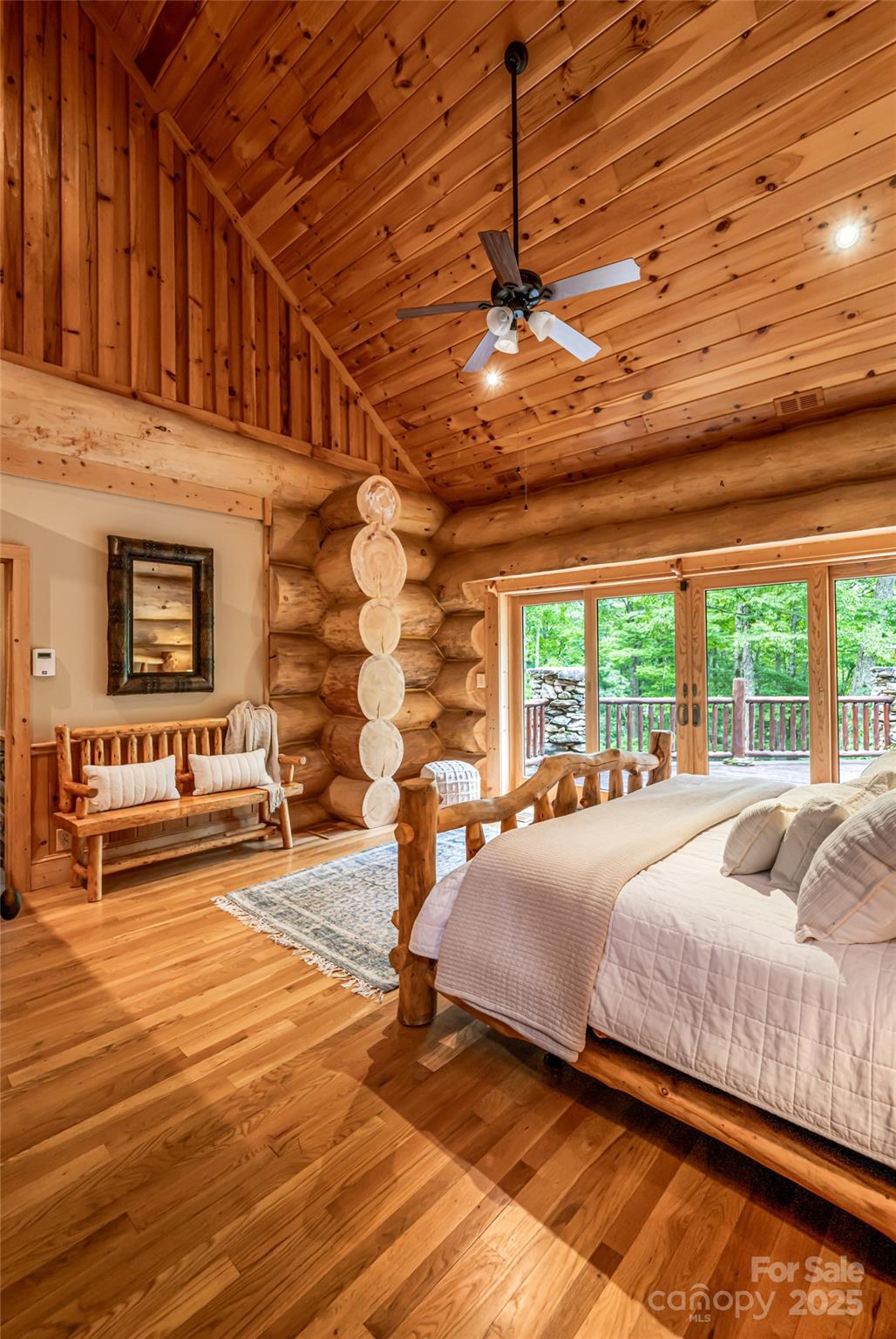 303 Flying Hawk Road Waynesville, NC 28786 - Photo 23 of 48 a spacious bedroom with a bed and a large window