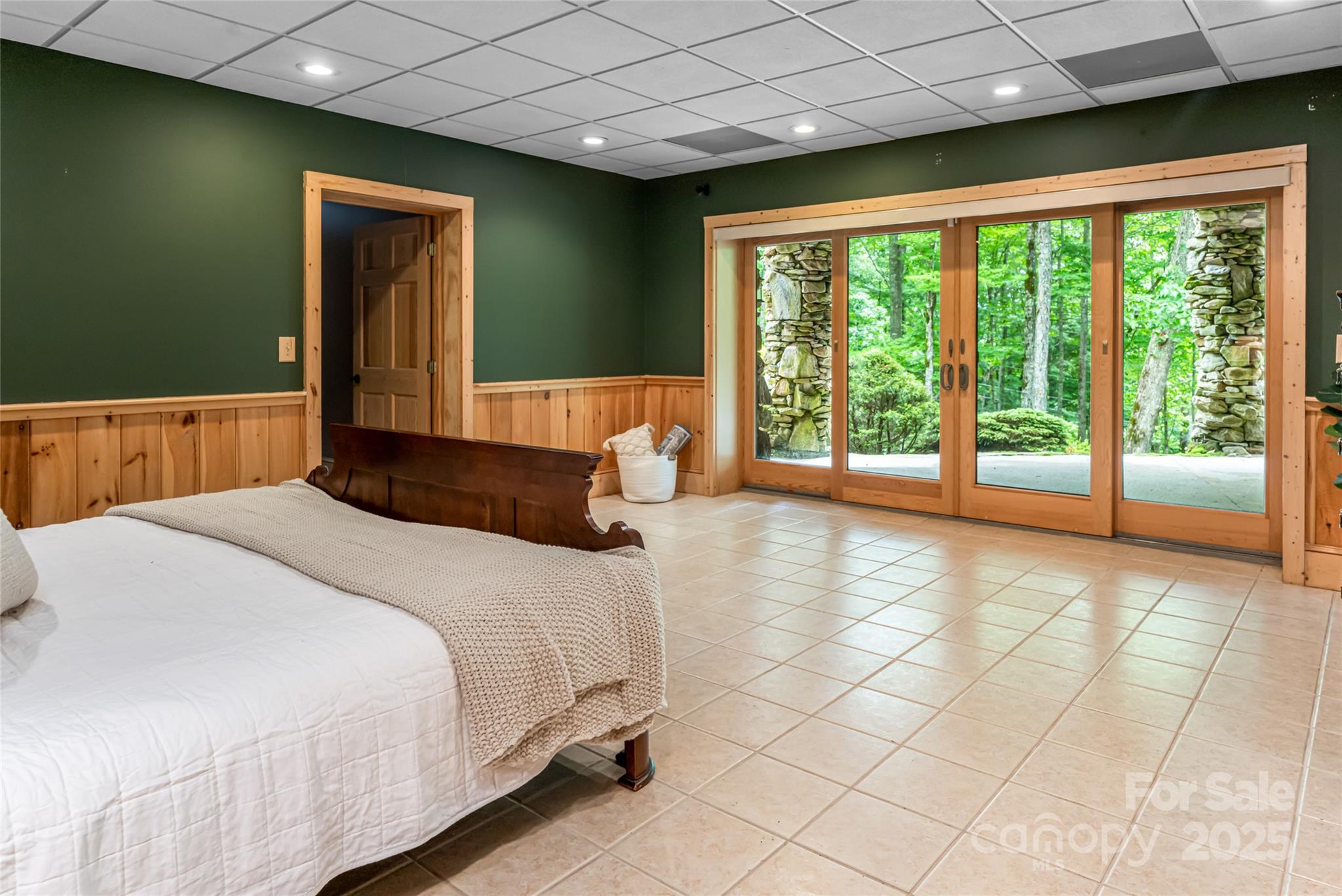 303 Flying Hawk Road Waynesville, NC 28786 - Photo 31 of 48 a bedroom with a large bed and a large window