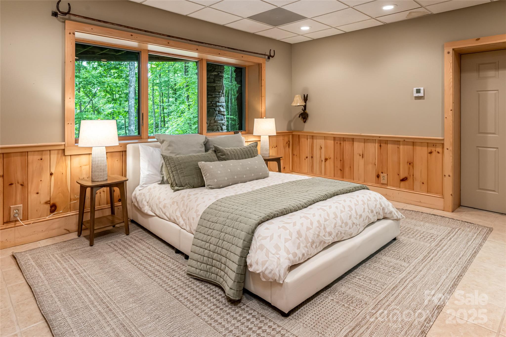 303 Flying Hawk Road Waynesville, NC 28786 - Photo 33 of 48 a bedroom with a large bed and a large window