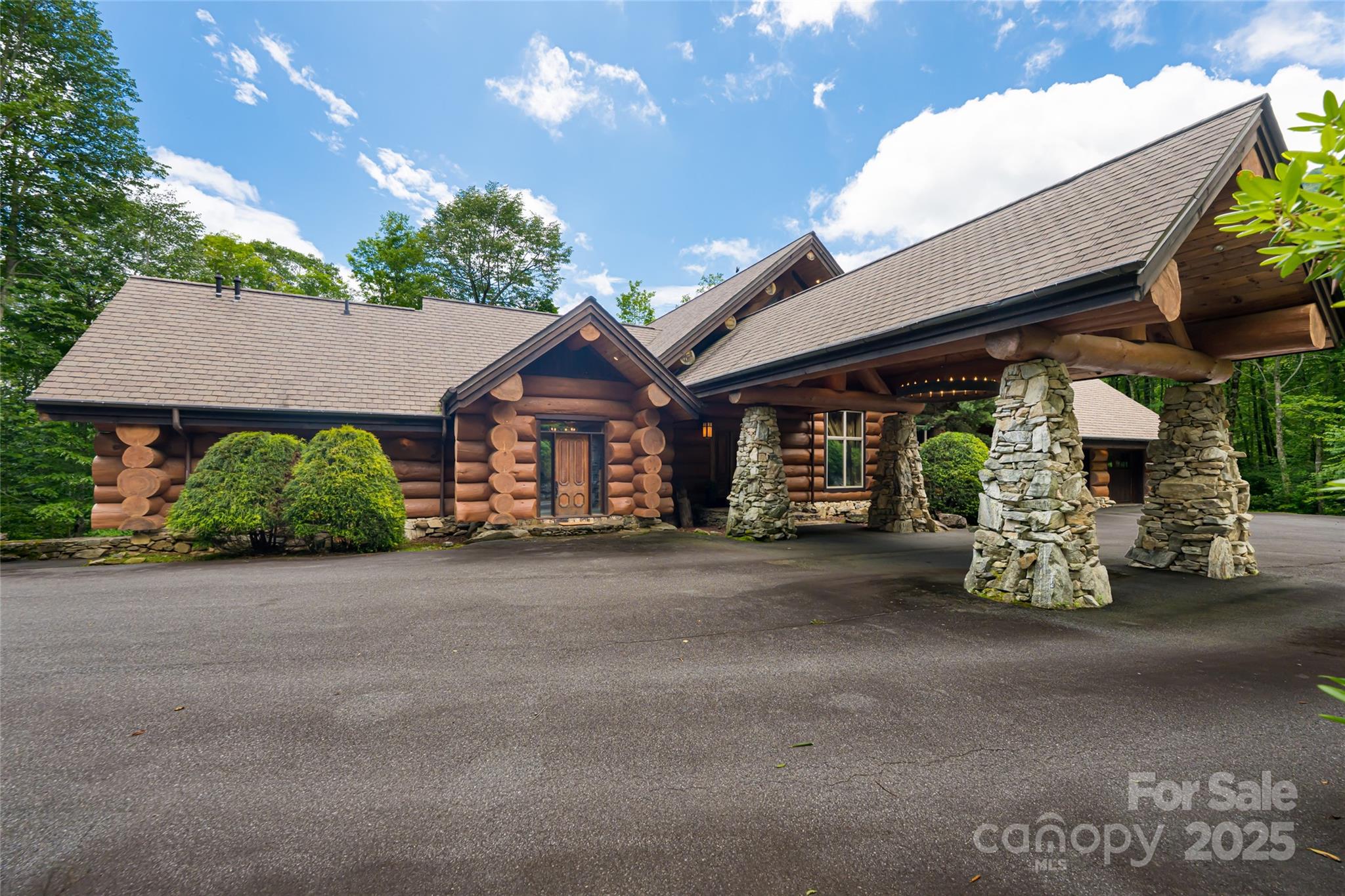 303 Flying Hawk Road Waynesville, NC 28786 - Photo 40 of 48 a front view of a house with garden
