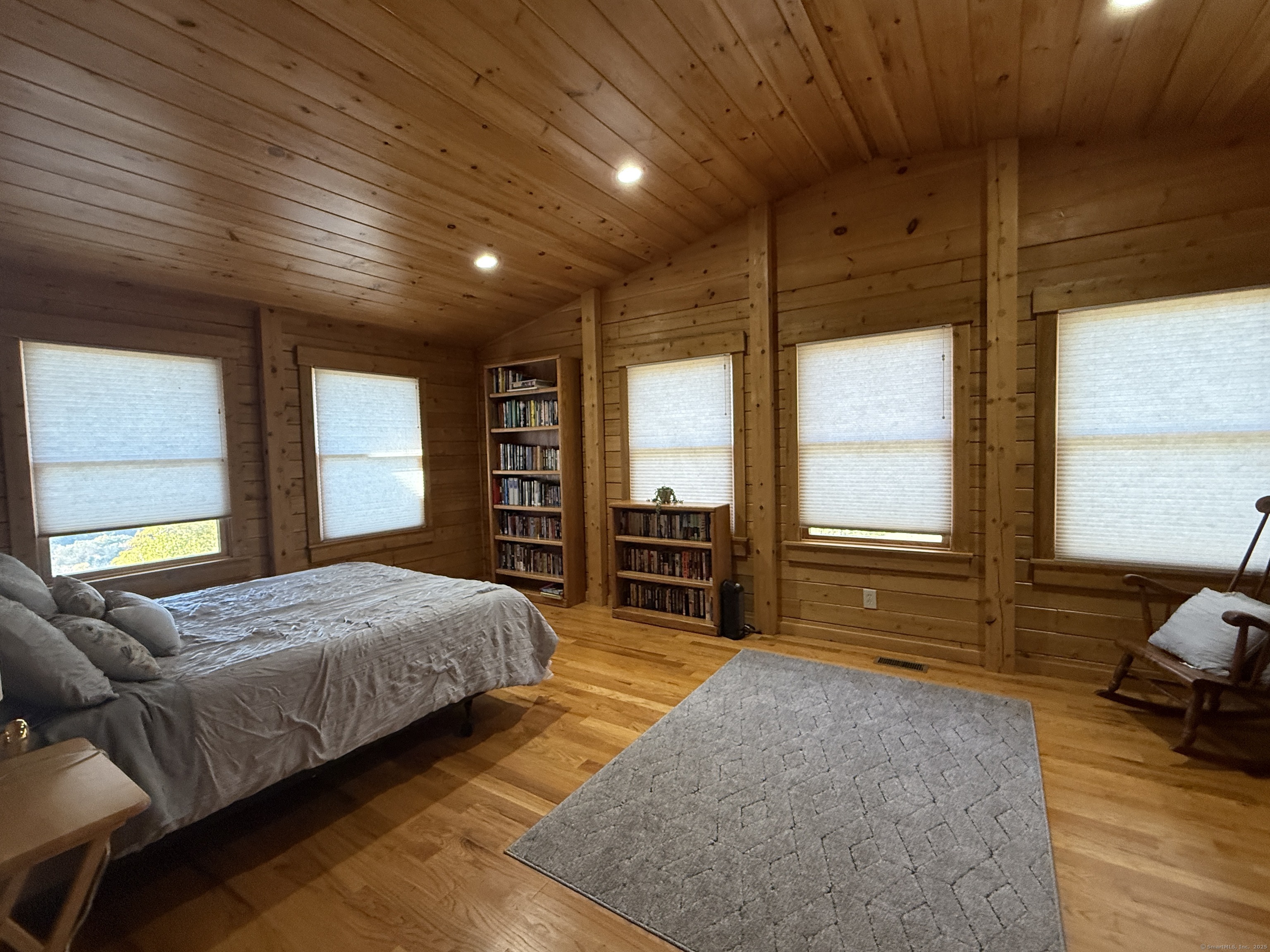 570 Long Mountain Road New Milford, CT 06776 - Photo 13 of 30 a spacious bedroom with a large bed and a large window