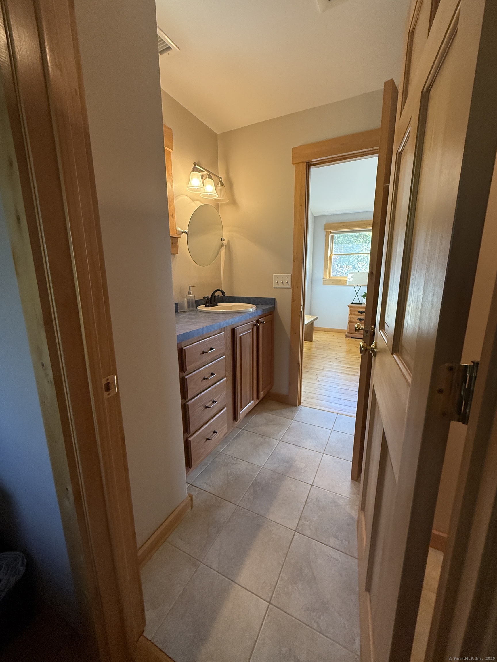 570 Long Mountain Road New Milford, CT 06776 - Photo 17 of 30 a bathroom with a sink and mirror