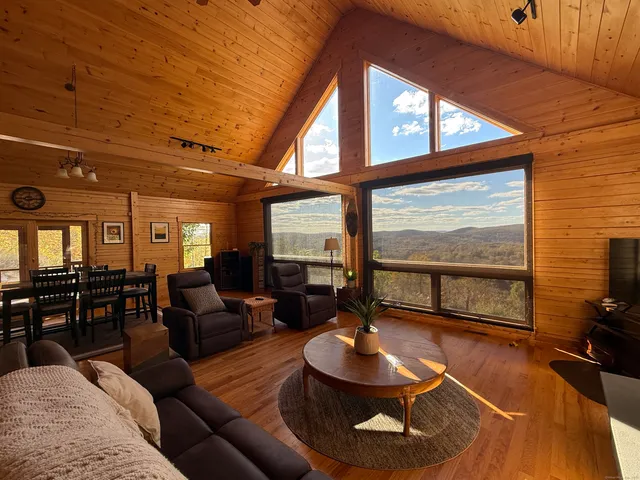 a living room with furniture and a floor to ceiling window