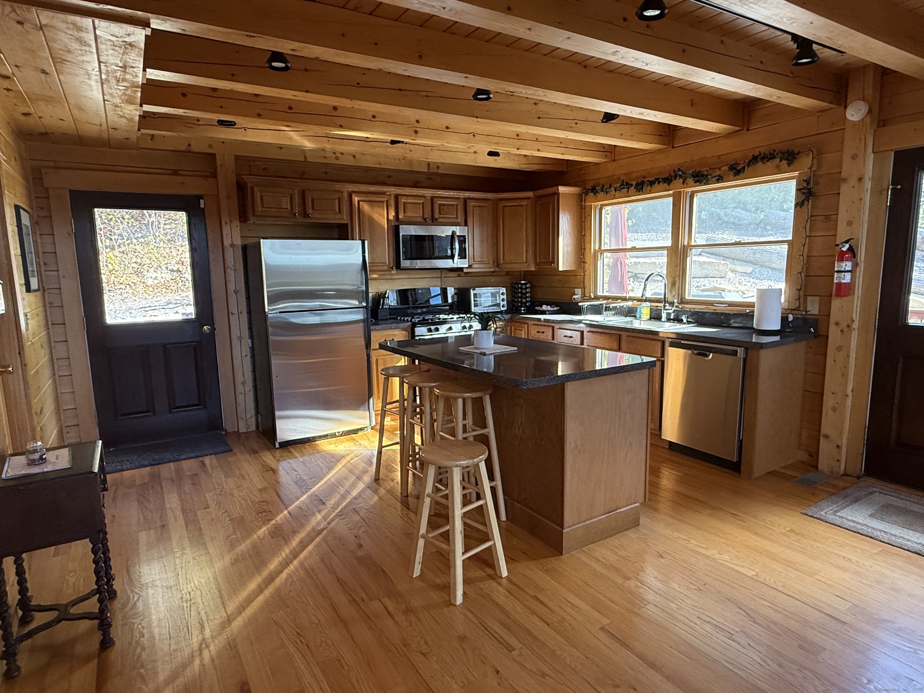 570 Long Mountain Road New Milford, CT 06776 - Photo 9 of 30 a kitchen with stainless steel appliances granite countertop a stove and a refrigerator
