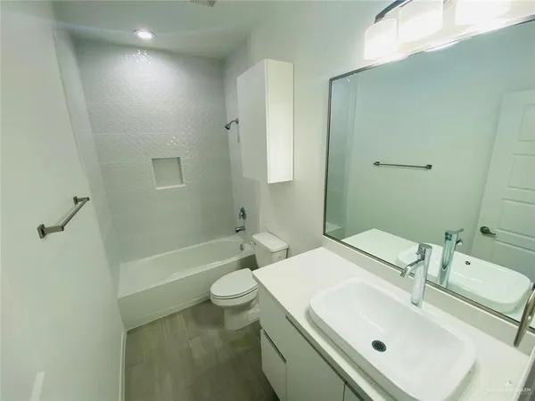 a bathroom with a sink toilet tub and shower