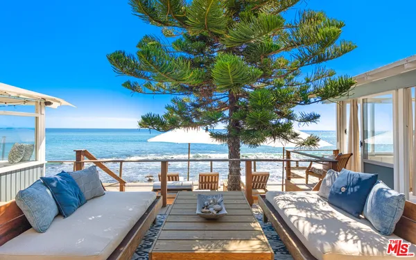a view of a patio with couches and pool